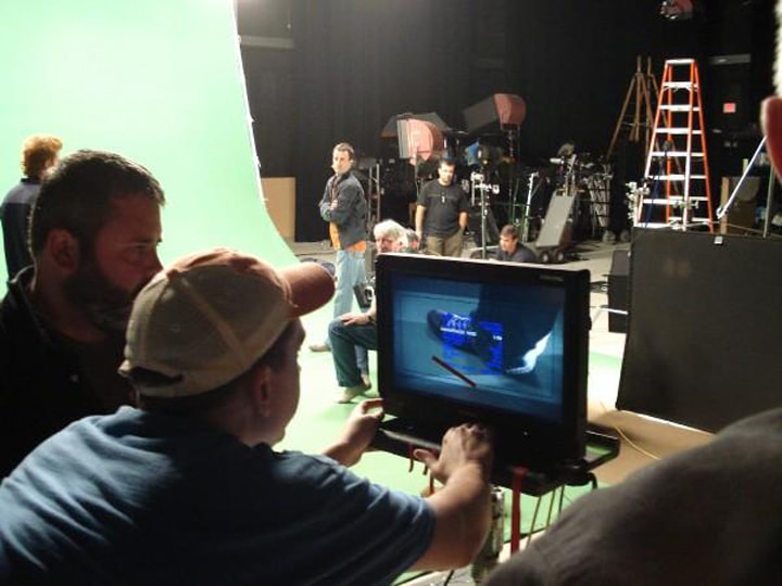 Behind the scenes — crew watching monitor on commercial set