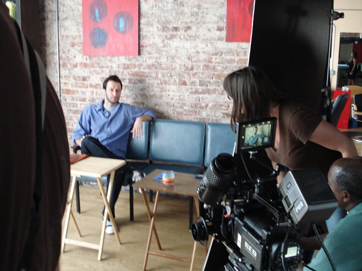 Dan Mengini being filmed in interview setup on set