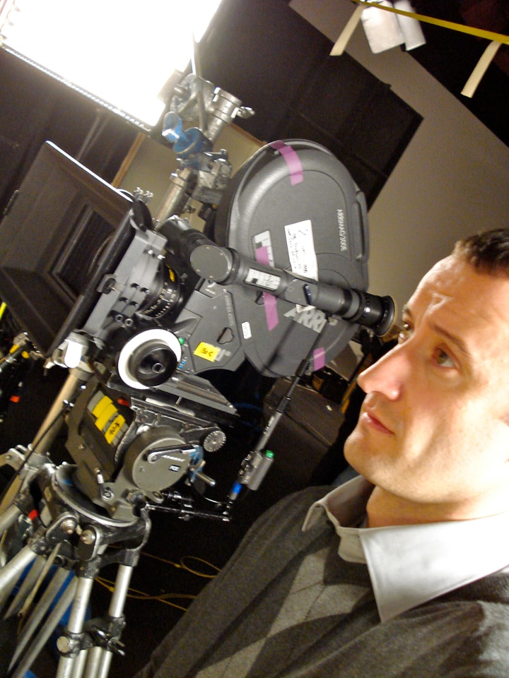 Dan Mengini next to ARRI film camera on set