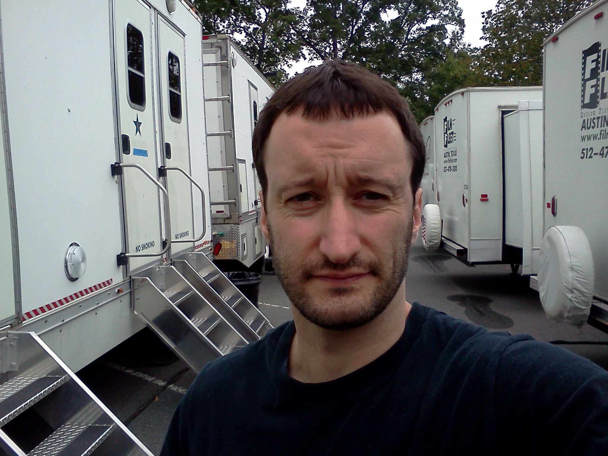 Dan Mengini selfie on location with production trailers
