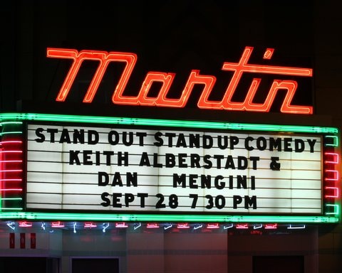 Dan Mengini performing on stage at a theater
