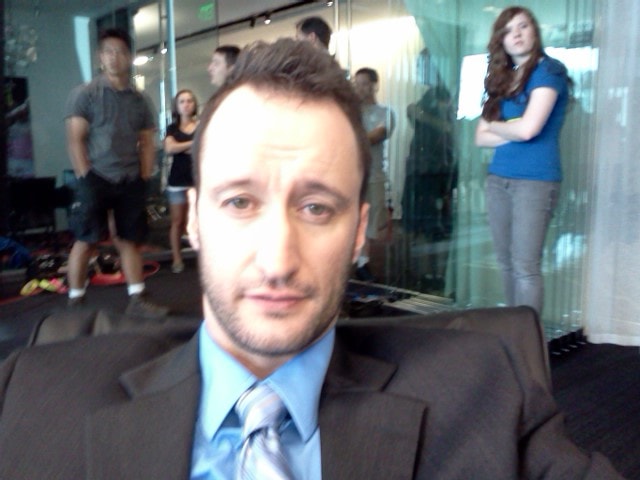 Dan Mengini on set in suit and tie