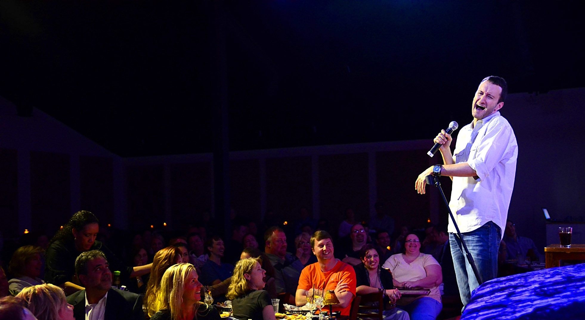 Dan Mengini performing at The Improv comedy club