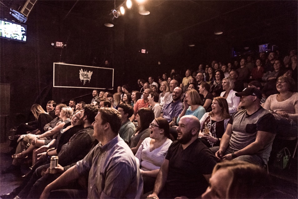 Laughing crowd at Village Theatre comedy show